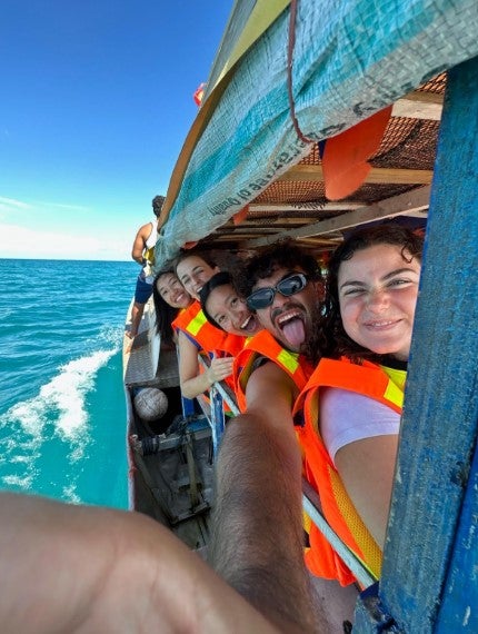 [Mary Nguyen (CAS ‘25) and peers on SIT Samoa: Social and Environmental Change in Oceania, on a sailboat in blue waters.]