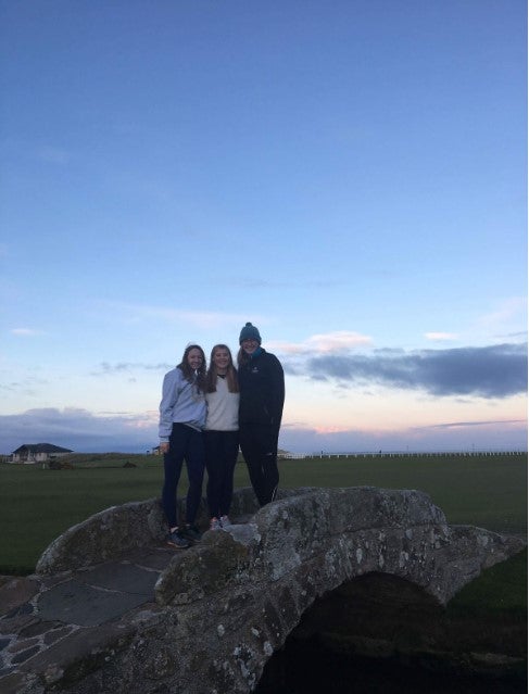 Nicole Heitsenrether (SFS ‘19) and friends at the University of St. Andrews, standing on top of a stone bridge against a sunset. 