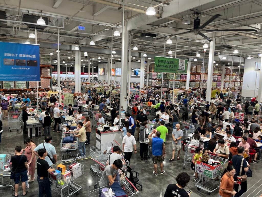 A busy grocery store with people and shopping carts