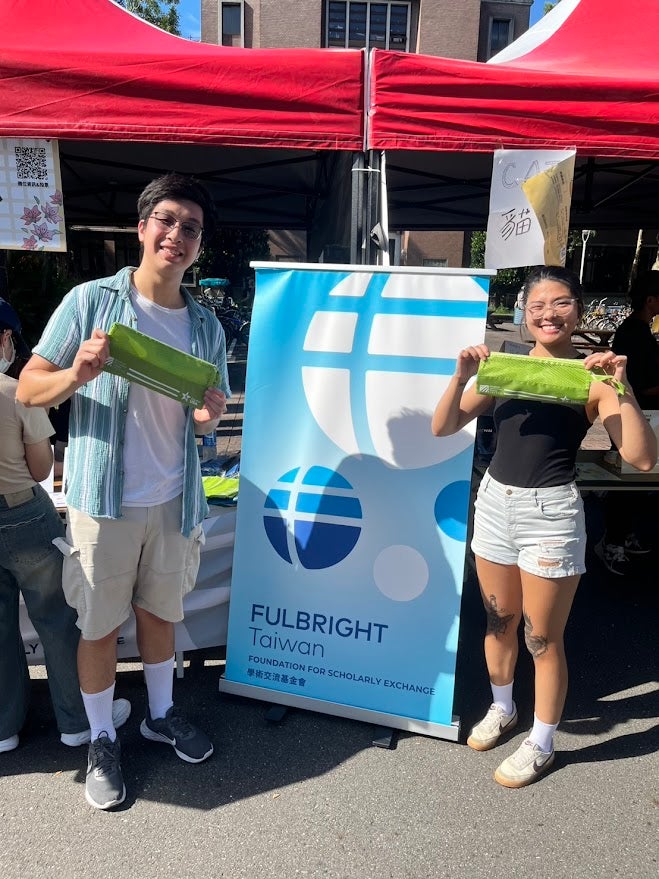 Jonathan and a colleague are standing with a "Fulbright Taiwan" sign separating them