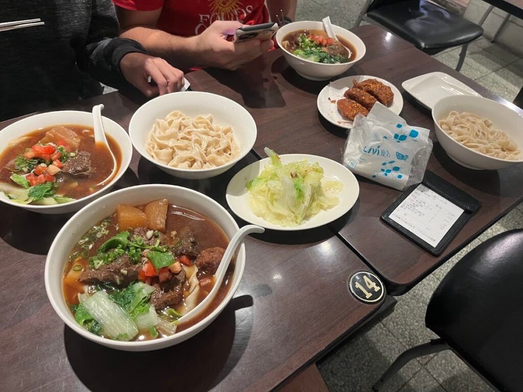 A bowl of beef stew with noodles