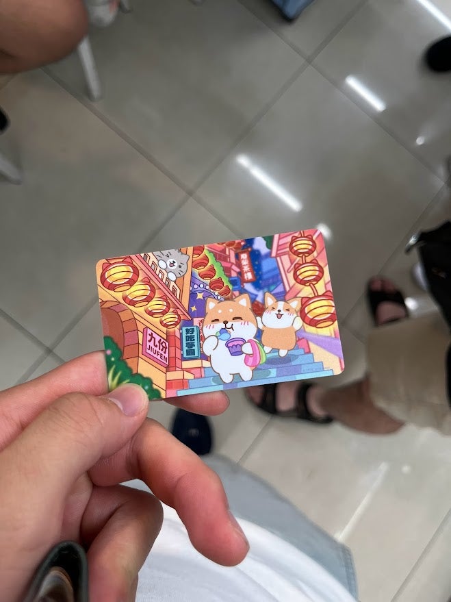 A metrocard that is themed with dogs and lanterns