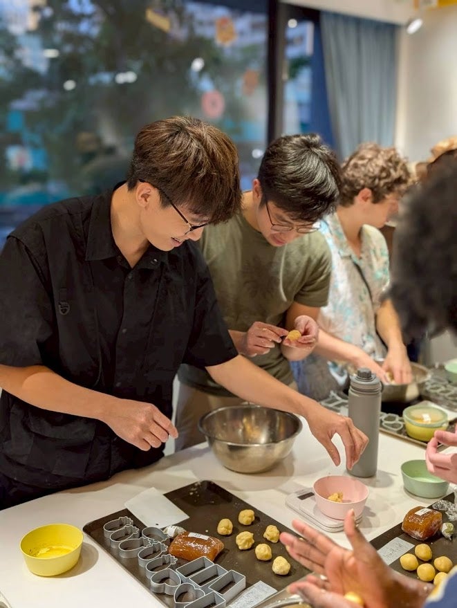 People constructing mooncakes starting with small dough balls