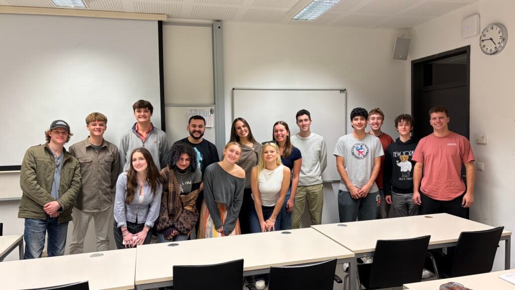 Group of students posing in a classroom